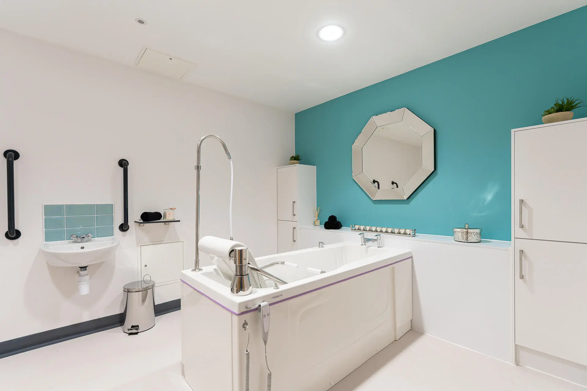 A large, accessible spa bath in a designated spa room at Surbitonian Gardens in Surbiton