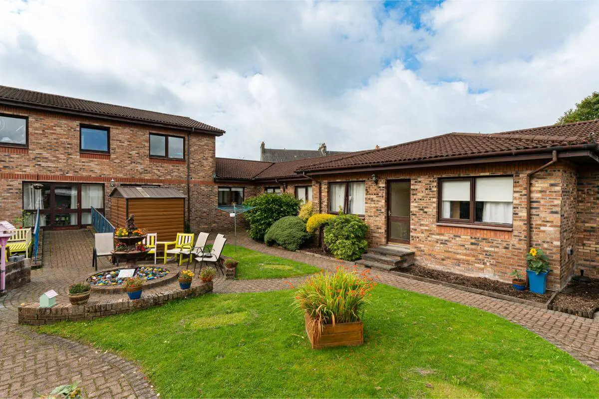 View of the lawned and seating areas in the garden at the back of Spiers Care Home