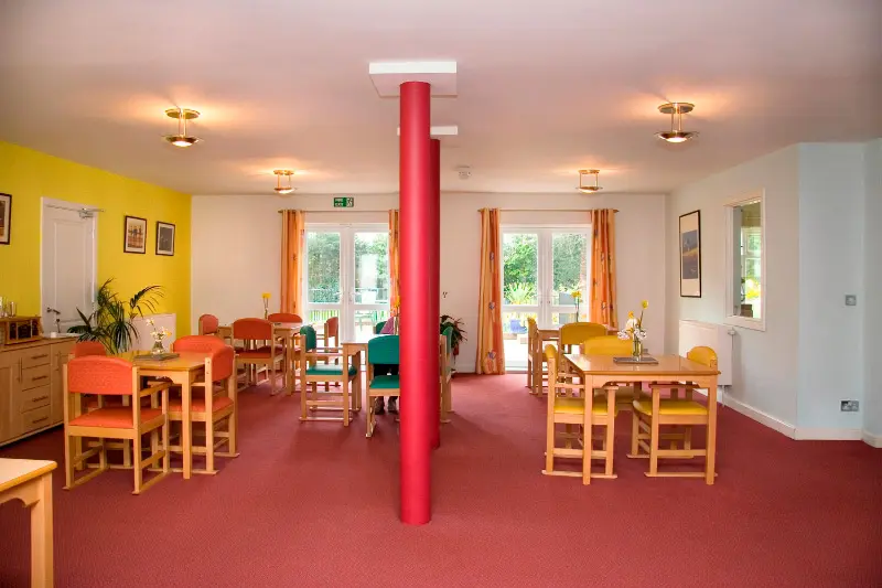 Wooden tables and chairs in a large room.