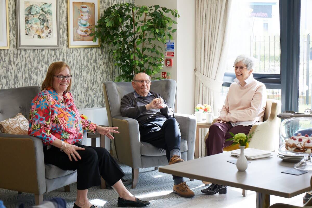 3 people sitting in arm chairs.