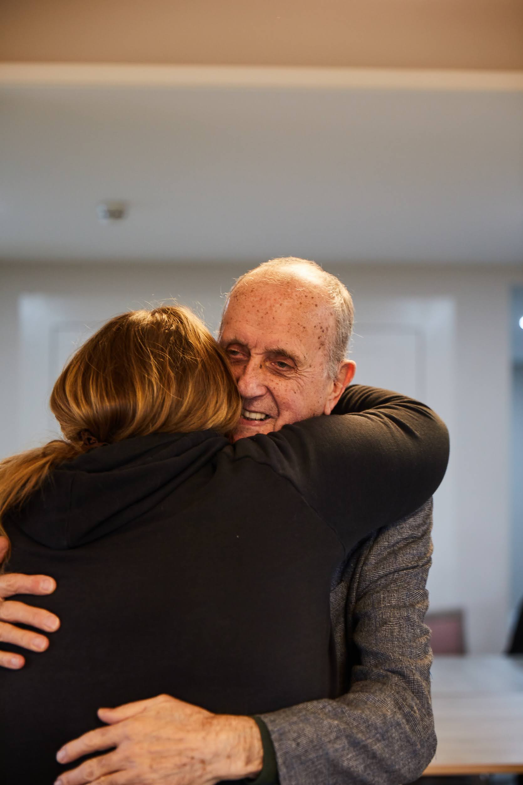 A guest hugging a staff member after their dance together at Brampton Lodge Day Centre.