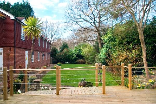 The grass lawn and decking in the Marlborough House Care Home garden.