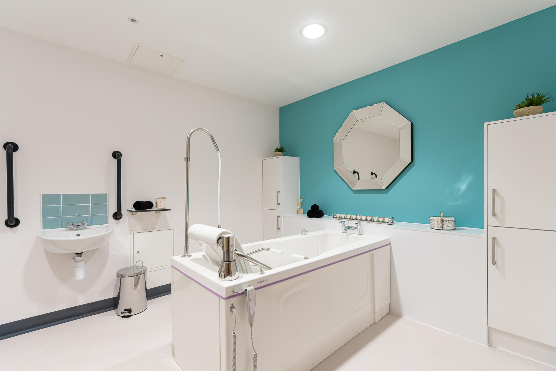 A large, accessible spa bath in a designated spa room at Surbitonian Gardens in Surbiton
