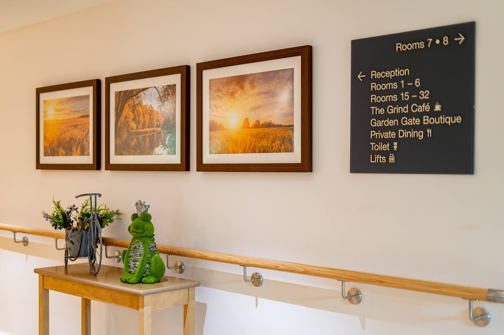Autumnal, countryside artwork and signage in the hallway at Surbitonian Gardens Care Home.