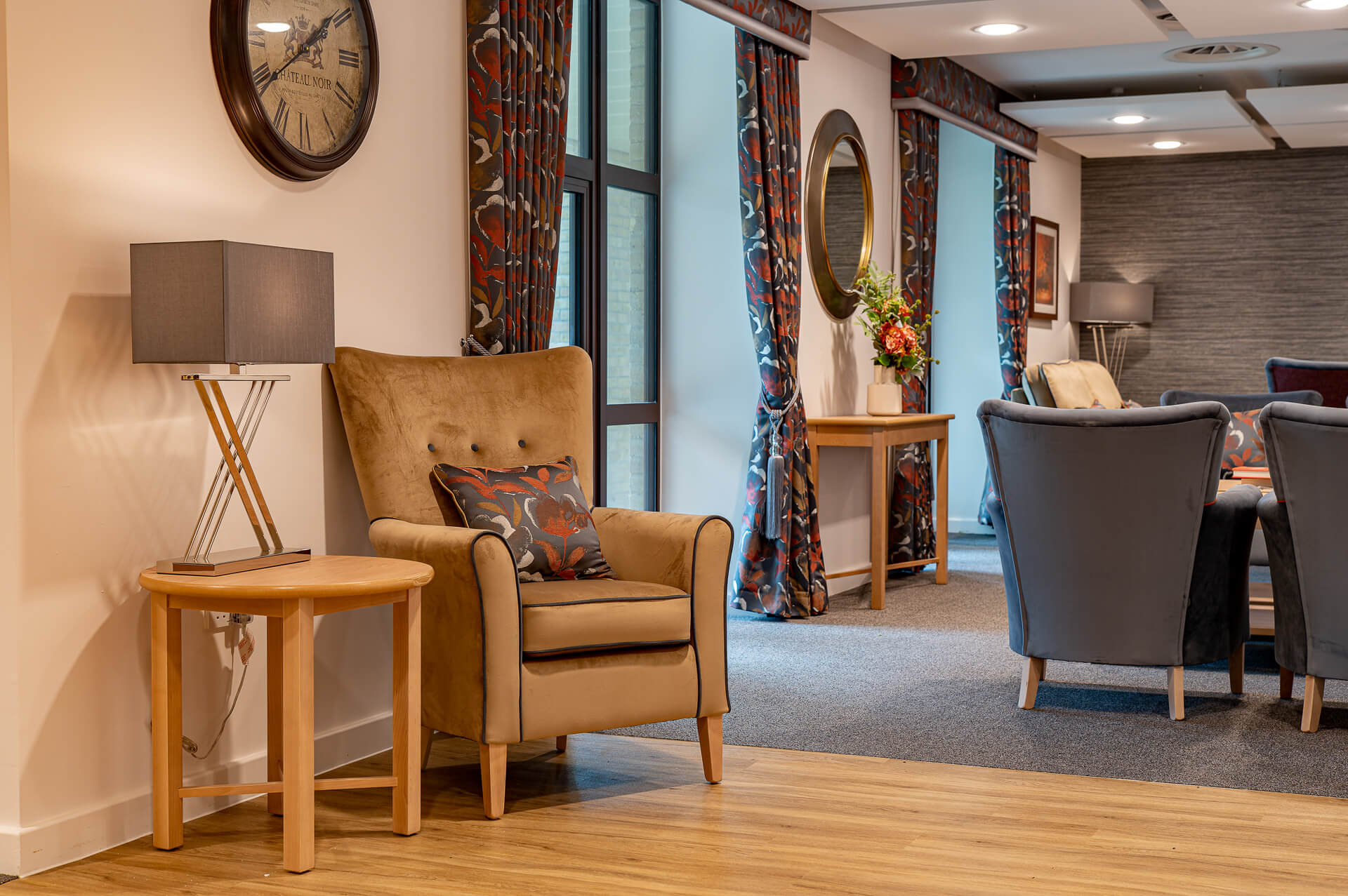 A beige, plush armchair in a lounge at Surbitonian Gardens Care Home.