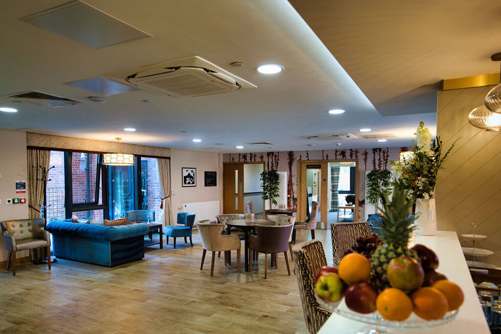 Sofas, chairs, tables and bar stools laid out in a room.