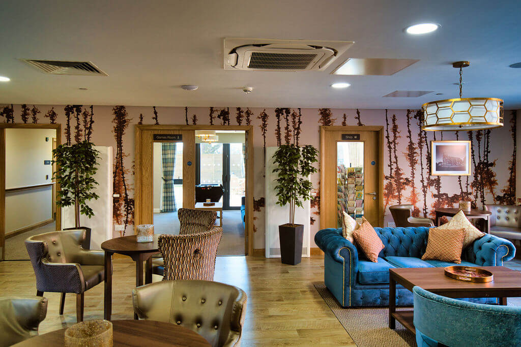 Cushioned chairs and sofas in a communal room.
