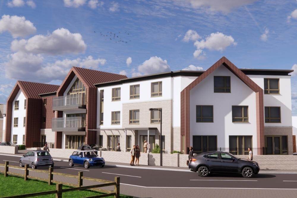 3 storey, white rendered care home building on a corner of a road.