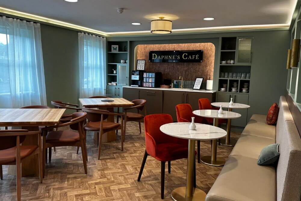 View of tables, chairs and bench seating in a little café room