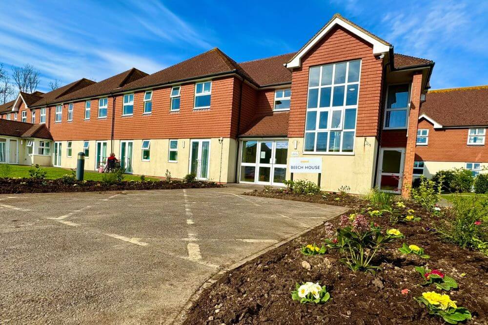 Large building with red tiling on second floor and yellow render on ground floor exterior.